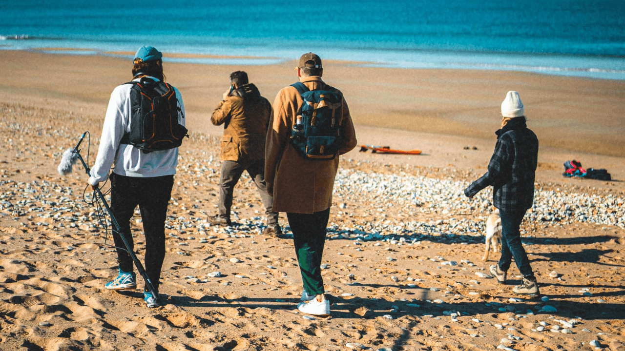 Video team walking on the beach